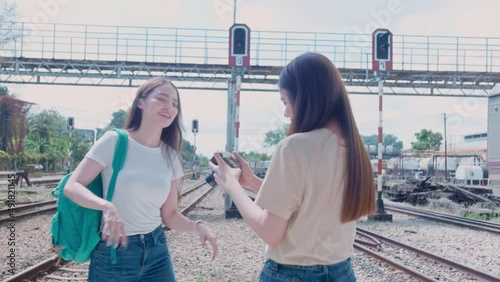 Asian beautiful woman lesbian Lgbt couples taking a photo together while travel on vacation at train station. Asian young lesbian Lgbt relationship and travel concept for stock footage.