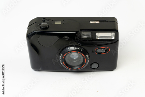 Vintage analog photo camera isolated on white background, old photo machine with lens front view, selective focus