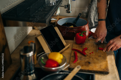 Fotografie, Obraz close up man cutting red paprika