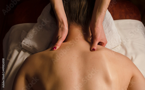 Young woman relaxes on thai massage, close up