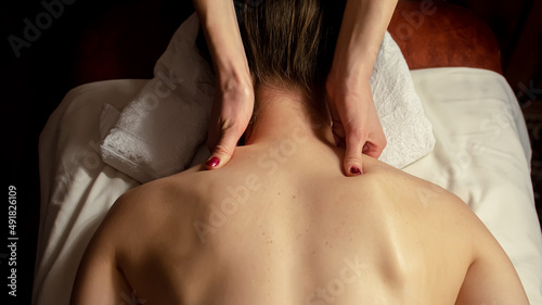 Young woman relaxes on thai massage, close up