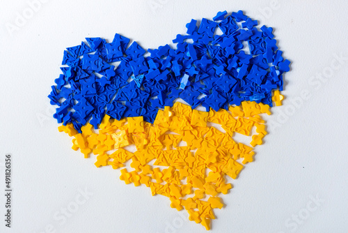 blue and yellow heart on white background