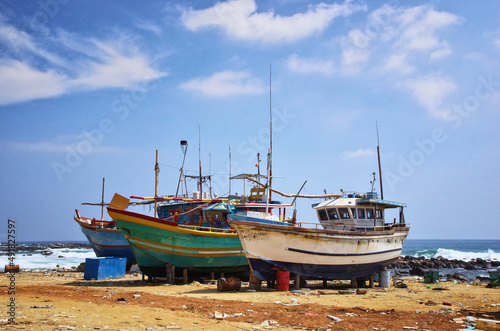 Dondra port  Sri Lanka. Abandoned fishing boats on the shore. Dirty harbor and old ships.