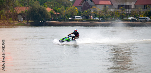 Man on jet ski having fun in the river with fast speed creating at lot of spray.Jet Ski Turn around and Speed with water splash.