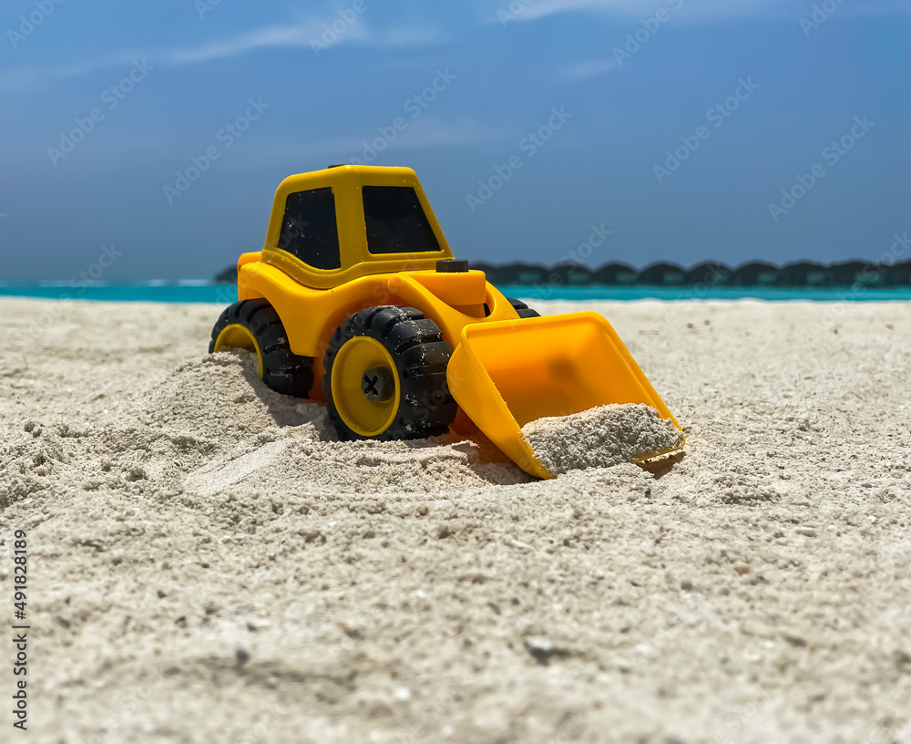 Childish loader on maldives tropical beach Childish loader on maldives tropical beach