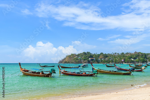 Wooden traditional boat at Rawai Beach with crystal clear water, famous tourist destination and resort area, Phuket, Thailand