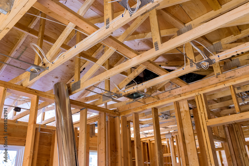 Framing of beams stick built house on new home under construction Framing of beams stick built house on new home under construction