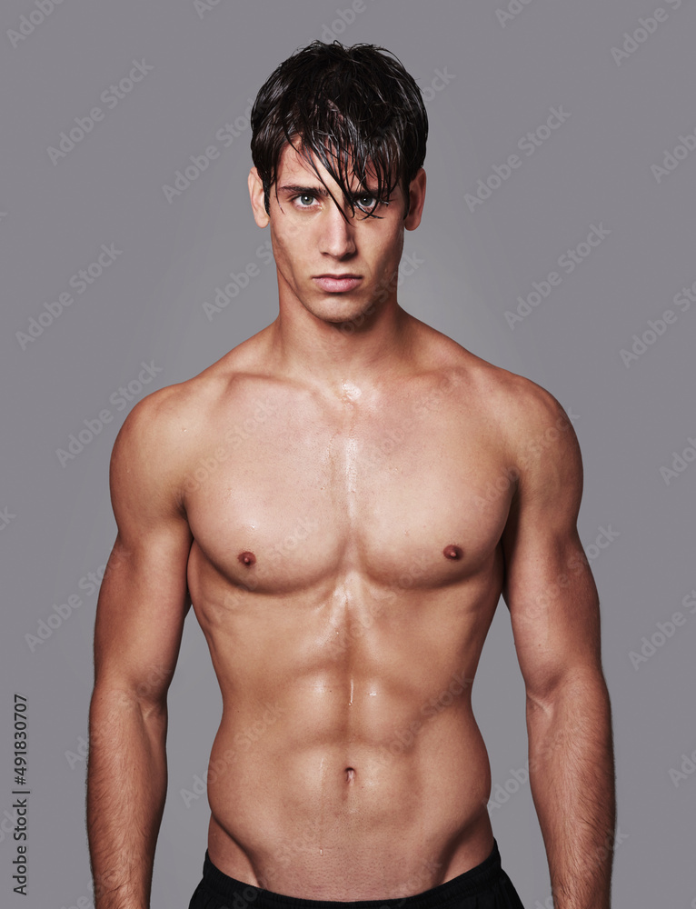 Hes one chiseled dude. A handsome young shirtless man posingPortrait of a handsome young shirtless man posing in the studioin studio. Hes one chiseled dude. A handsome young shirtless man posingPortrait of a handsome young shirtless man posing in the studioin studio.