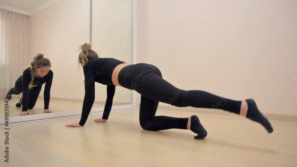Woman wearing black sport suite exercising at home Woman wearing black sport suite exercising at home