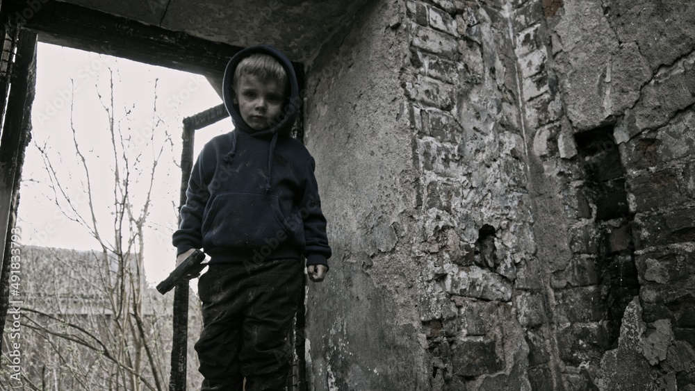 Child playing war in ruins Child playing war in ruins