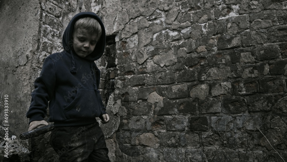 Child playing war in ruins Child playing war in ruins