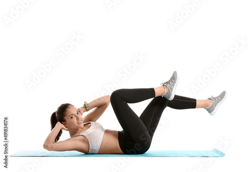 Sporty teenage girl doing fitness on white background