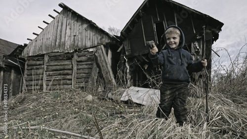 Child playing war in ruins 