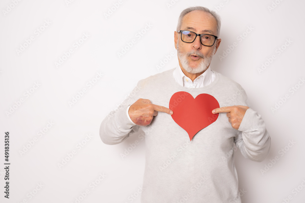 Happy senior man showing red paper heart isolated over white background. Health concept. Happy senior man showing red paper heart isolated over white background. Health concept.