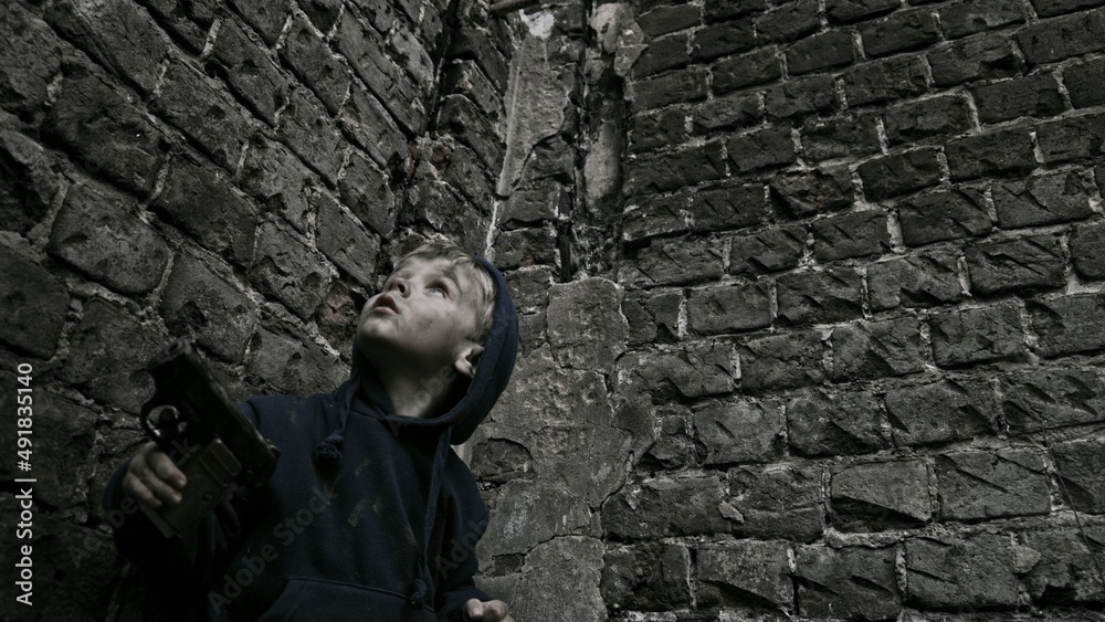 Child playing war in ruins Child playing war in ruins