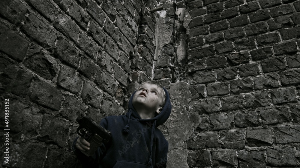 Child playing war in ruins Child playing war in ruins