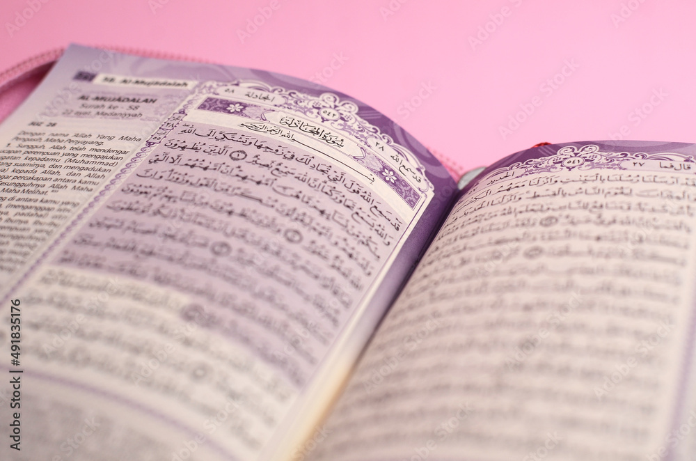 Muslim Al-Quran with Indonesian translation on pink background Muslim Al-Quran with Indonesian translation on pink background