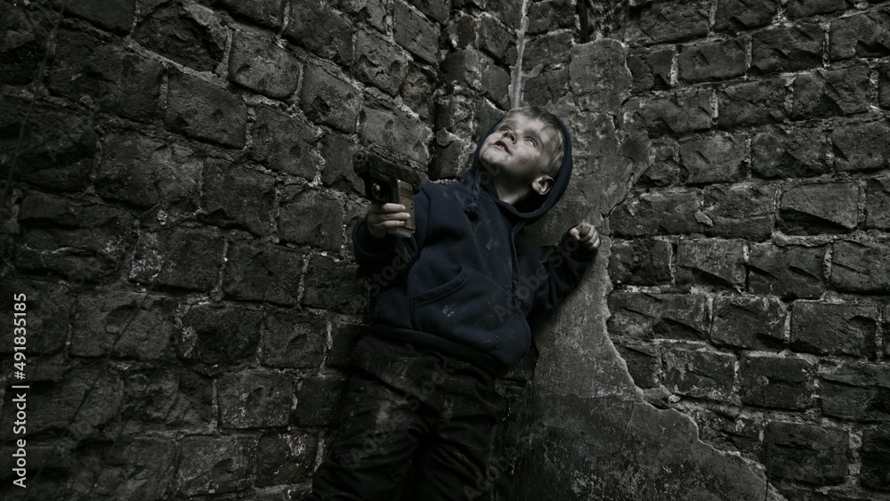 Child playing war in ruins Child playing war in ruins
