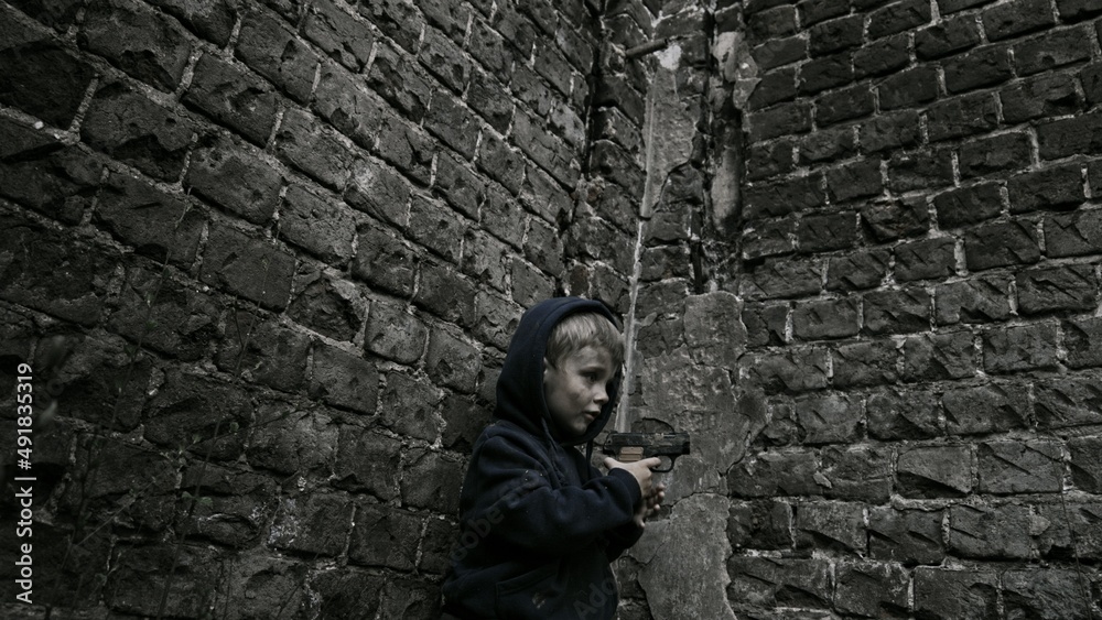 Child playing war in ruins Child playing war in ruins