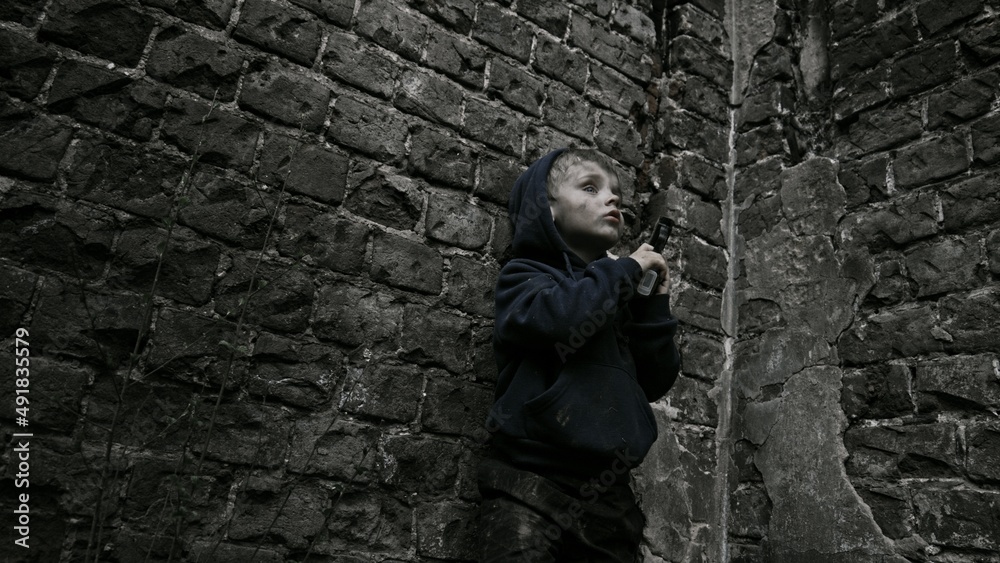 Child playing war in ruins Child playing war in ruins