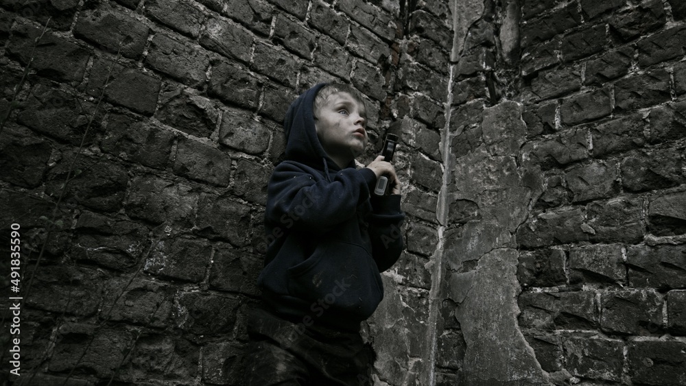Child playing war in ruins Child playing war in ruins