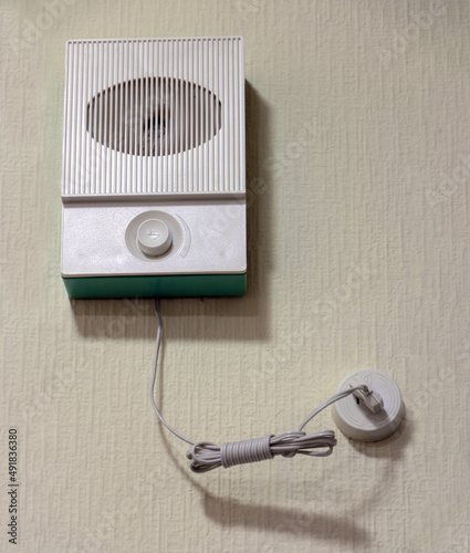 Retro wired radio on wall in room.
