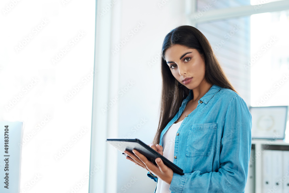 Be smart when chasing after your ambitions. Portrait of a young businesswoman using a digital tablet in an office. Be smart when chasing after your ambitions. Portrait of a young businesswoman using a digital tablet in an office.