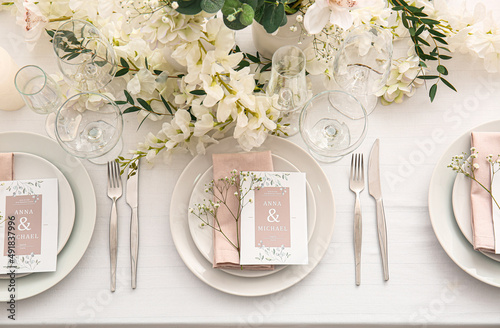 Fototapeta Stylish table setting with wedding invitations and gypsophila flowers, top view