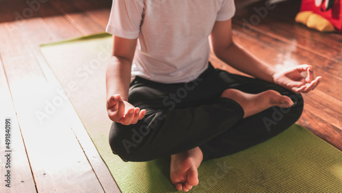 asian boy meditating alone at home peacefullyv