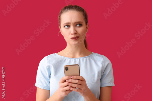 Thoughtful young woman with...