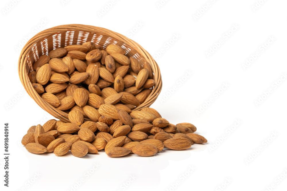 Almond. Overturned basket with almonds isolated on white background. Almond. Overturned basket with almonds isolated on white background.