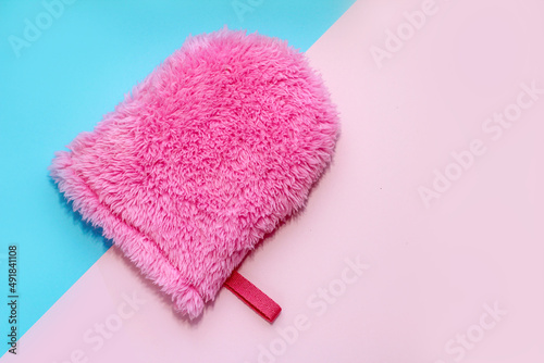 Reusable sponge glove for washing face on abstract background.