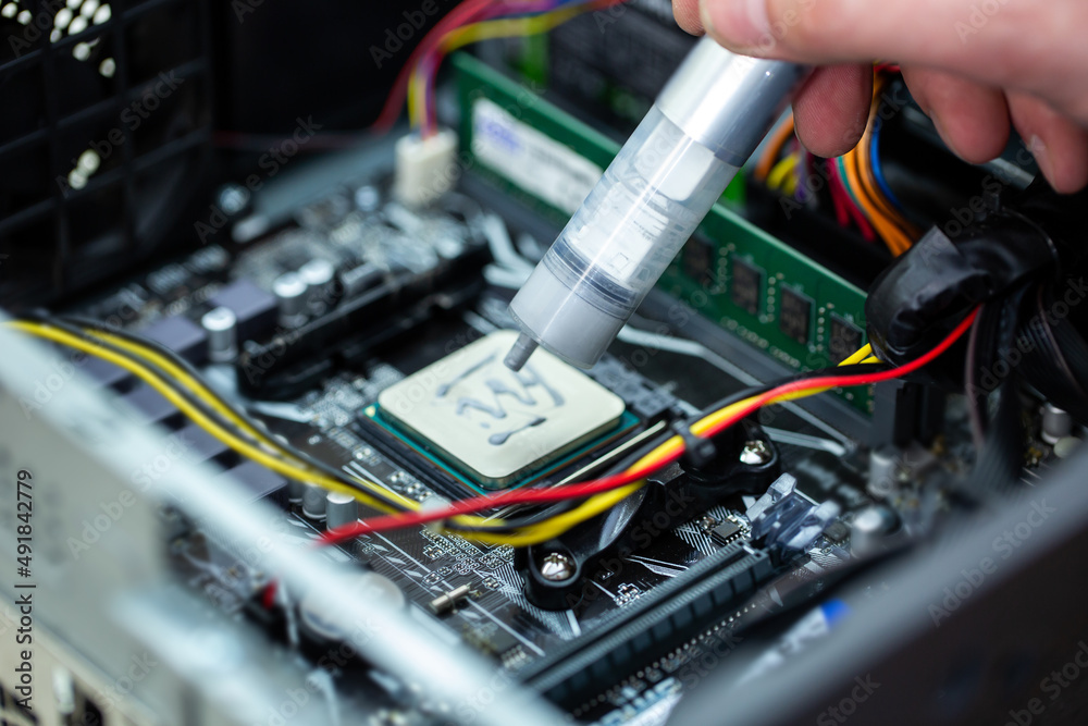 Naklejka premium Thermal paste is applied to the laptop processor