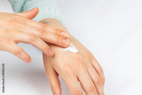 woman hand taking cream on white background