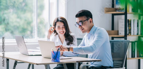 Two Asian businesspeople working at office