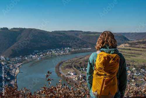Photos Hiker with backpack enjoys the view from the Teufelslay vantage point in the Mos