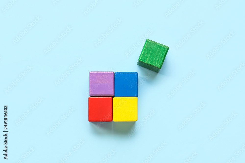 Obraz premium Colorful cubes on blue background. Concept of autistic disorder