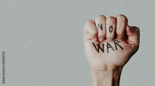 Valokuva clenched fist with the text no war written in it