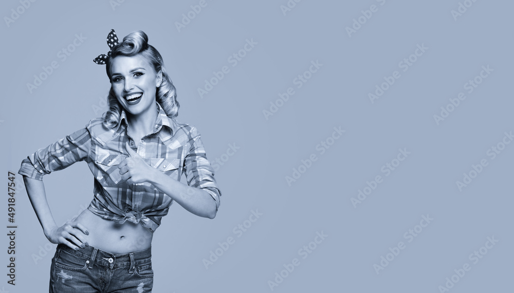 Portrait of beautiful young happy smiling woman, showing thumb up gesture, dressed in pin-up style. Caucasian blond girl in retro fashion and vintage concept. Black and white. Copy space. Portrait of beautiful young happy smiling woman, showing thumb up gesture, dressed in pin-up style. Caucasian blond girl in retro fashion and vintage concept. Black and white. Copy space.