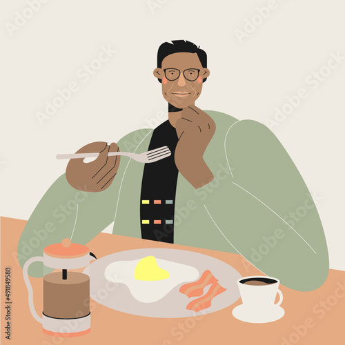 Hombre moreno con lentes desayunando y disfrutando de huevo con cafe
