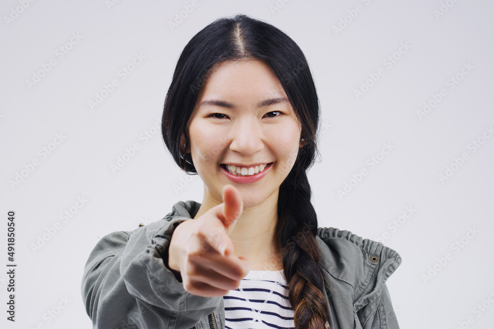 Youre the chosen one. Portrait of a beautiful young woman pointing to the camera against a grey background. Youre the chosen one. Portrait of a beautiful young woman pointing to the camera against a grey background.
