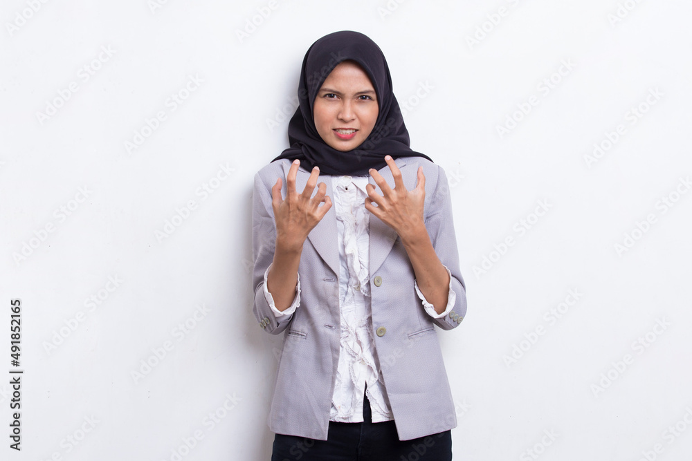 young asian muslim woman angry emotional shouting and screaming on white background
