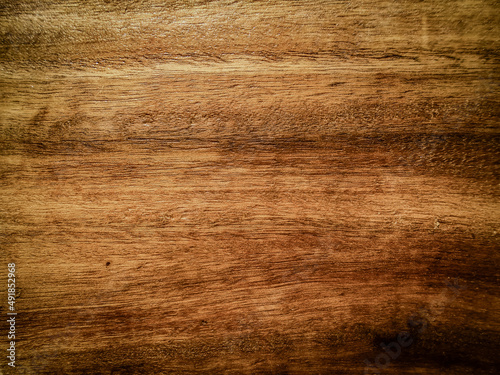 Wooden texture background in faded style. Dark brown timber is empty for creating design. Close up of plank hardwood table floor with natural pattern