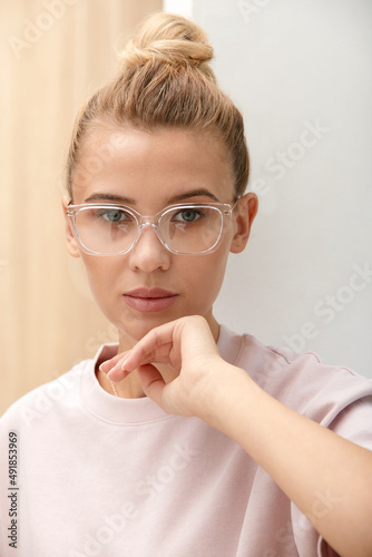 Close-up shot of smiling attractive happy and successful european blond female in sweater watch and glasses grinning expressing confidence, looking accomlished and daring at camera with sassy smile.