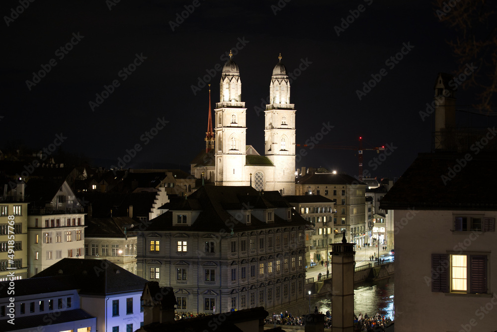 Illuminated protestant church Great Minster at the old town of Zürich on a winter night. Photo taken February 24th, 2022, Zurich, Switzerland.