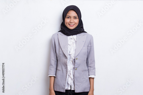 Young asian muslim woman in head scarf smile with arms crossed on white background 