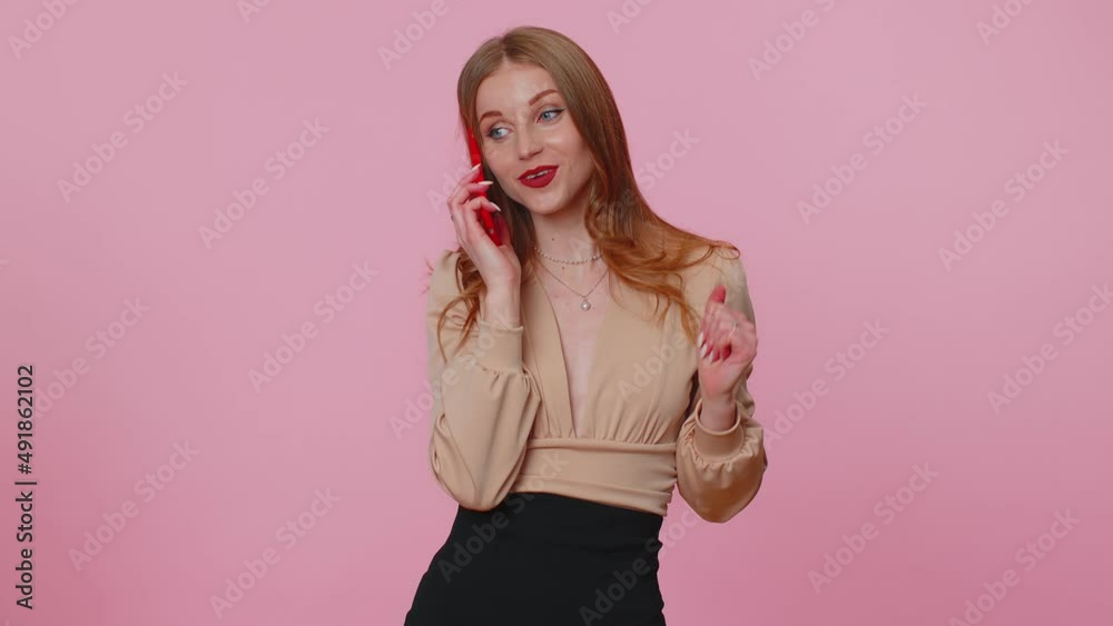 Happy businesswoman girl in beige blouse having pleasant mobile conversation using smartphone with friends or family, telling good news. Young adult woman isolated alone on pink studio background Happy businesswoman girl in beige blouse having pleasant mobile conversation using smartphone with friends or family, telling good news. Young adult woman isolated alone on pink studio background