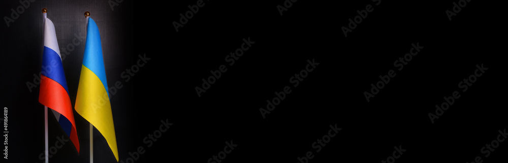 Small flags of the Russia and Ukraine on a black background.Ukraine russia conflict.Relations between Ukraine and Russia, sanctions,concept of war.Please stop war Small flags of the Russia and Ukraine on a black background.Ukraine russia conflict.Relations between Ukraine and Russia, sanctions,concept of war.Please stop war