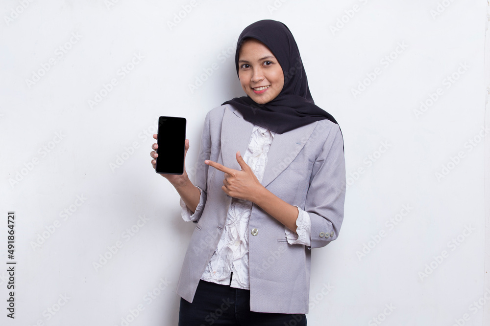 young beautiful asian muslim woman demonstrating mobile cell phone isolated on white background
young beautiful asian muslim woman demonstrating mobile cell phone isolated on white background