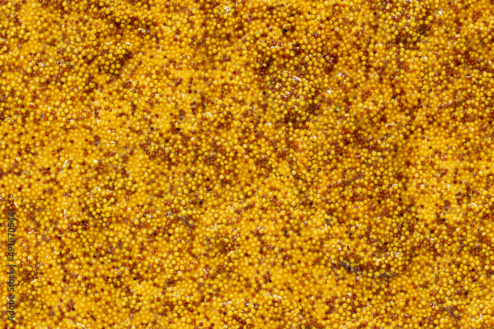 Abstract Dijon mustard background with dark and light mustard seeds Abstract Dijon mustard background with dark and light mustard seeds